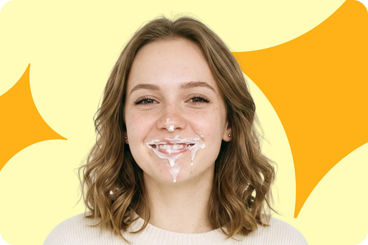 Donna sorridente con del liquido bianco che le cola dalla bocca